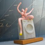 Intriguing Sculpture Debuts Outside New Museum Featuring a Playful Nude Figure